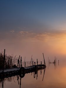 Preview wallpaper pier, sunset, lake, fishing nets