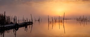 Preview wallpaper pier, sunset, lake, fishing nets