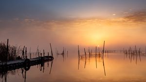 Preview wallpaper pier, sunset, lake, fishing nets