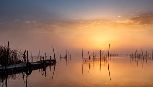 Preview wallpaper pier, sunset, lake, fishing nets