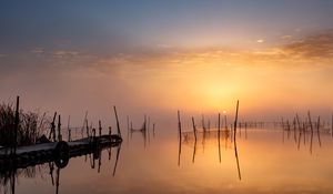 Preview wallpaper pier, sunset, lake, fishing nets