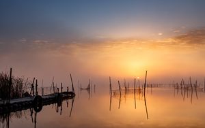 Preview wallpaper pier, sunset, lake, fishing nets