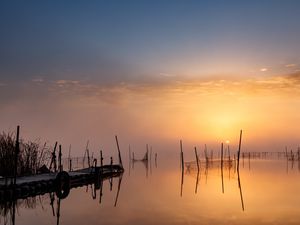 Preview wallpaper pier, sunset, lake, fishing nets