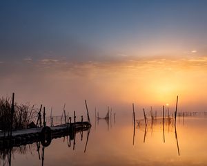 Preview wallpaper pier, sunset, lake, fishing nets