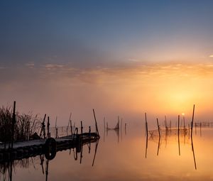 Preview wallpaper pier, sunset, lake, fishing nets