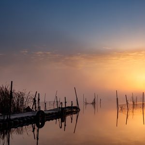 Preview wallpaper pier, sunset, lake, fishing nets