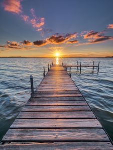 Preview wallpaper pier, sunset, rays, horizon, sea