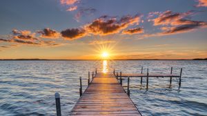 Preview wallpaper pier, sunset, rays, horizon, sea