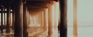 Preview wallpaper pier, tunnel, waves, sunlight, beach