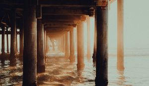 Preview wallpaper pier, tunnel, waves, sunlight, beach