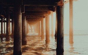 Preview wallpaper pier, tunnel, waves, sunlight, beach