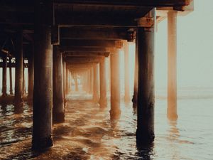 Preview wallpaper pier, tunnel, waves, sunlight, beach