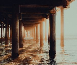 Preview wallpaper pier, tunnel, waves, sunlight, beach