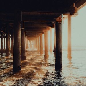 Preview wallpaper pier, tunnel, waves, sunlight, beach