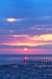 Preview wallpaper pilings, sea, sunset