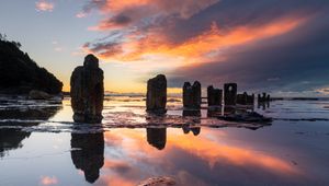 Preview wallpaper pillars, stones, water, reflection, nature, sunset