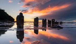 Preview wallpaper pillars, stones, water, reflection, nature, sunset