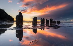 Preview wallpaper pillars, stones, water, reflection, nature, sunset