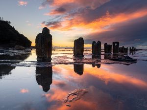 Preview wallpaper pillars, stones, water, reflection, nature, sunset