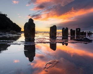 Preview wallpaper pillars, stones, water, reflection, nature, sunset