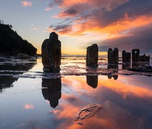 Preview wallpaper pillars, stones, water, reflection, nature, sunset