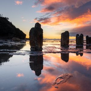 Preview wallpaper pillars, stones, water, reflection, nature, sunset