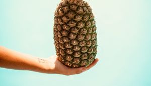 Preview wallpaper pineapple, hand, fruit