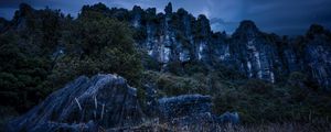 Preview wallpaper piopio, new zealand, mountains, rocks, grass, evening