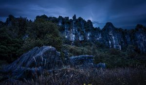 Preview wallpaper piopio, new zealand, mountains, rocks, grass, evening