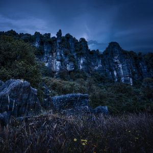 Preview wallpaper piopio, new zealand, mountains, rocks, grass, evening