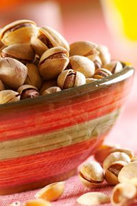 Preview wallpaper pistachios, nuts, plate, table
