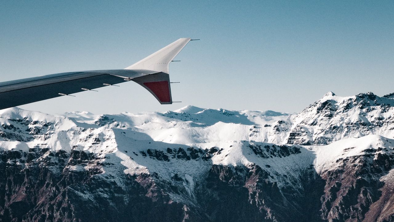 Wallpaper plane, mountains, rocks, clouds
