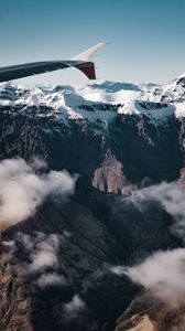 Preview wallpaper plane, mountains, rocks, clouds