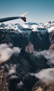 Preview wallpaper plane, mountains, rocks, clouds