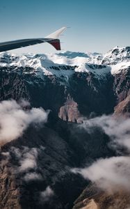 Preview wallpaper plane, mountains, rocks, clouds