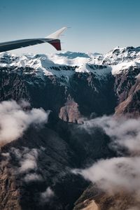 Preview wallpaper plane, mountains, rocks, clouds