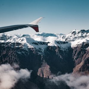 Preview wallpaper plane, mountains, rocks, clouds