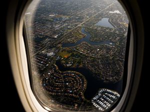 Preview wallpaper plane, porthole, city, aerial view