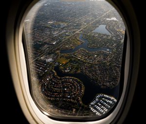 Preview wallpaper plane, porthole, city, aerial view