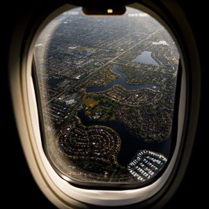 Preview wallpaper plane, porthole, city, aerial view