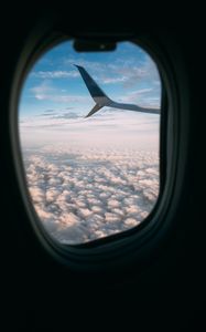 Preview wallpaper plane, wing, porthole, view, clouds