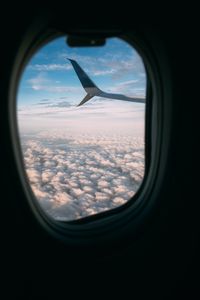 Preview wallpaper plane, wing, porthole, view, clouds