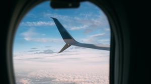 Preview wallpaper plane, wing, porthole, view, clouds