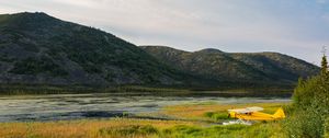 Preview wallpaper plane, yellow, field, hills, landscape