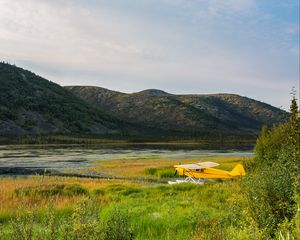 Preview wallpaper plane, yellow, field, hills, landscape