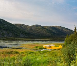 Preview wallpaper plane, yellow, field, hills, landscape