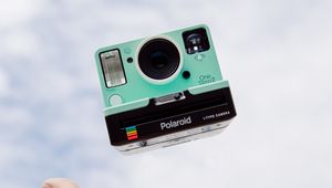 Preview wallpaper polaroid, camera, hand, sky