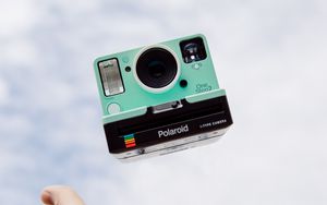 Preview wallpaper polaroid, camera, hand, sky