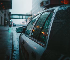 Preview wallpaper police, car, street, city, rain, fog