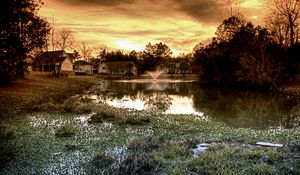 Preview wallpaper pond, fountain, houses, cloudy, evening